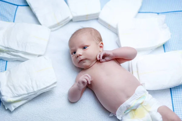 Newborn baby on changing table with diapers — Stock Photo, Image