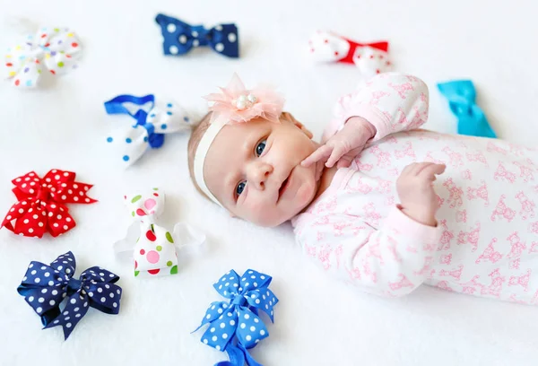 Cute adorable newborn baby child with colorful bows — Stock Photo, Image