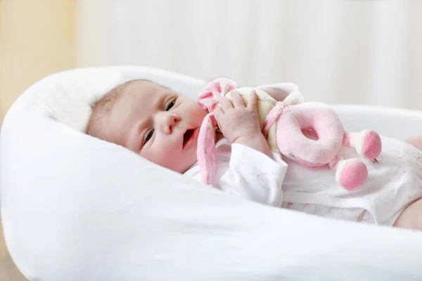 Cute baby girl playing with plush animal toy — Stock Photo, Image