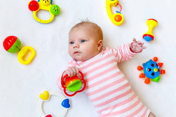 Bonito bebê menina brincando com brinquedos chocalho colorido — Fotografia de Stock