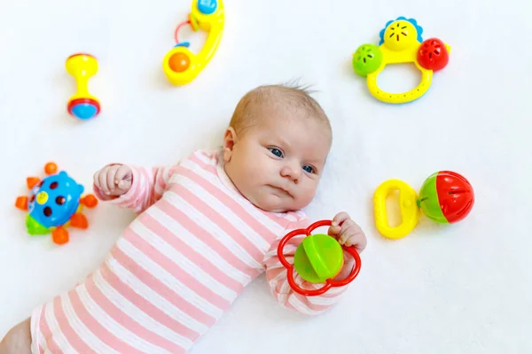 Bonito bebê menina brincando com brinquedos chocalho colorido — Fotografia de Stock