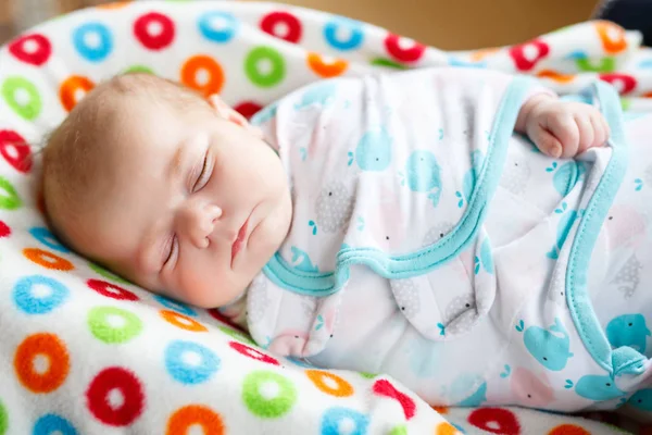 Cute little newborn baby girl sleeping wrapped in blanket — Stock Photo, Image