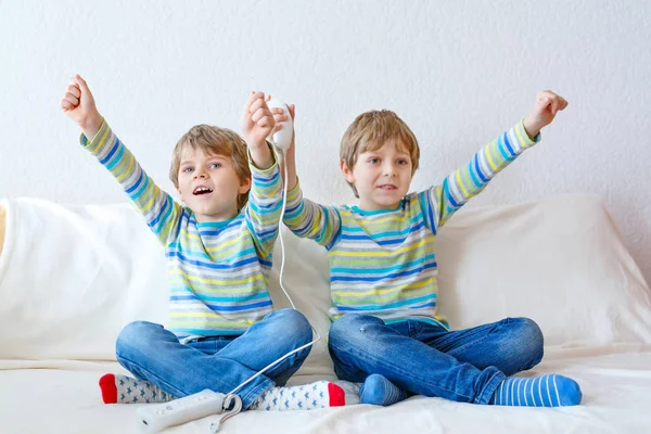 Dois garotinhos jogando videogame em casa — Fotografia de Stock