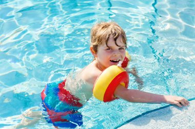Mutlu küçük çocuk çocuk yüzme havuzuna eğleniyor
