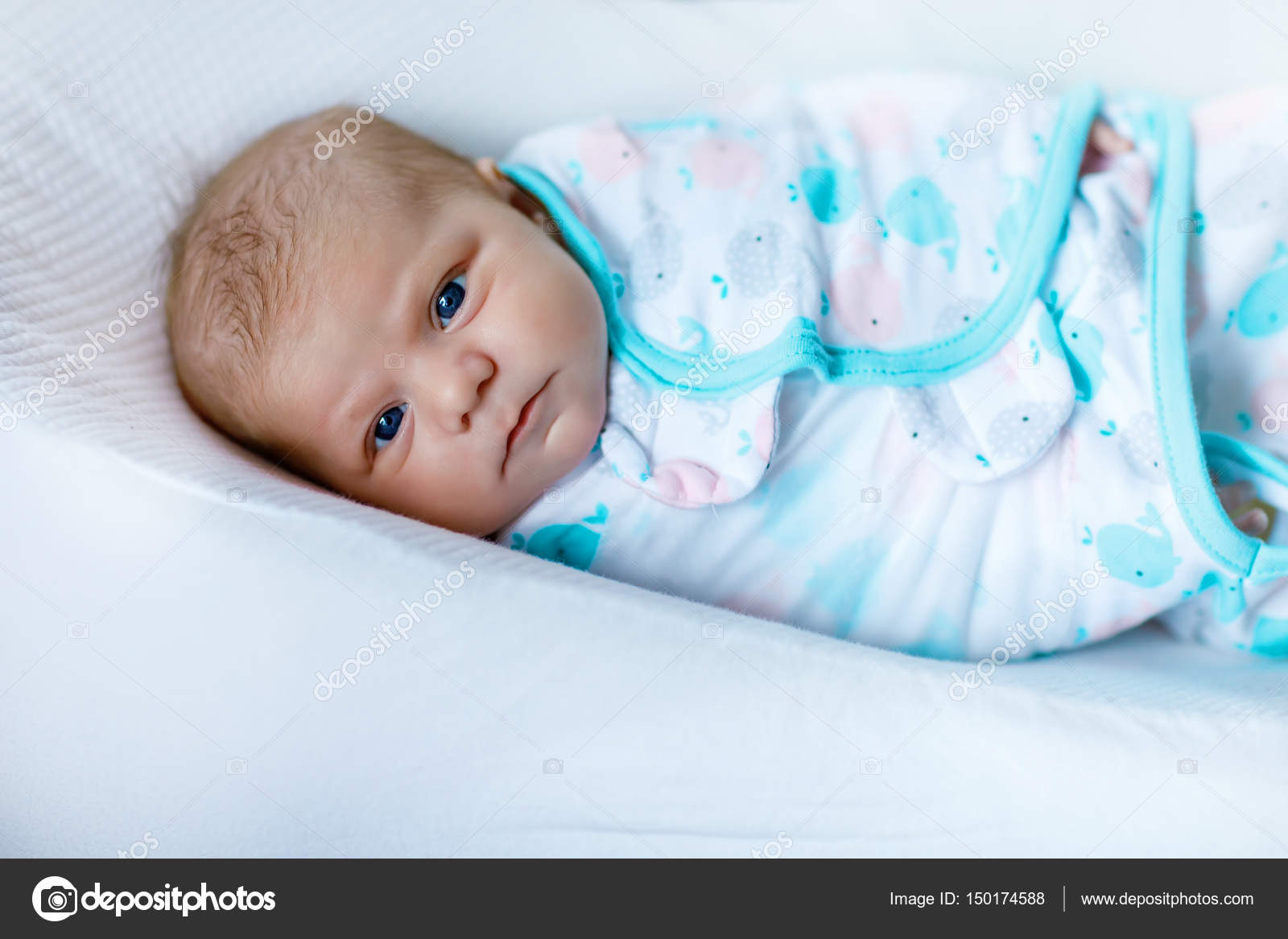 Cute little newborn baby girl wrapped in blanket Stock Photo by