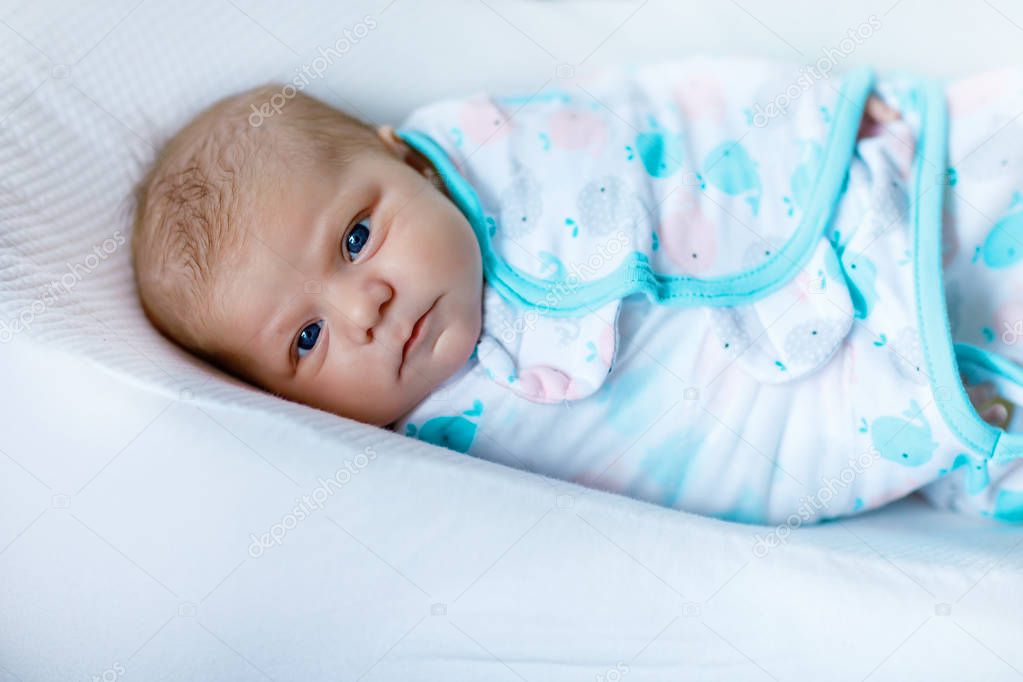 Cute little newborn baby girl wrapped in blanket