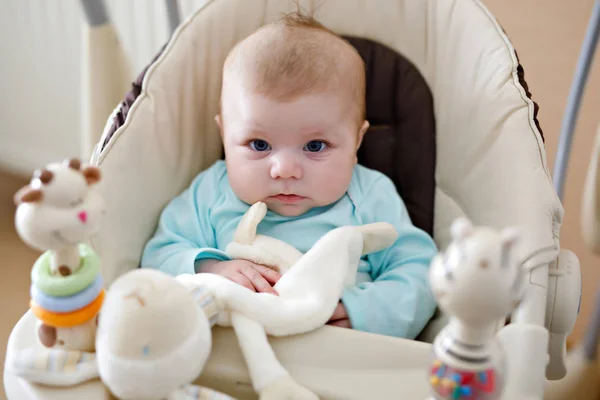 Cute adorable newborn baby sitting in swing — Stock Photo, Image