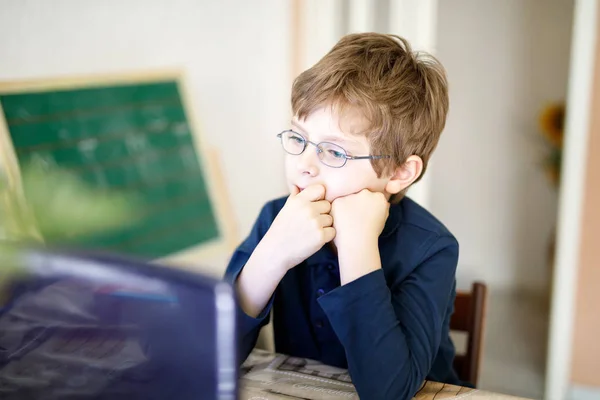Bambino ragazzo con gli occhiali facendo compiti di scuola materna sul computer — Foto Stock