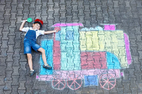 Little kid boy having fun with train chalks picture — Stock Photo, Image