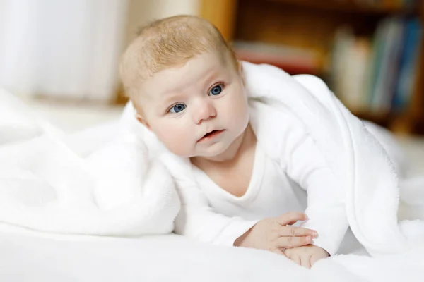 Baby girl wearing white towel or winter overal in white sunny bedroom — Stock Photo, Image