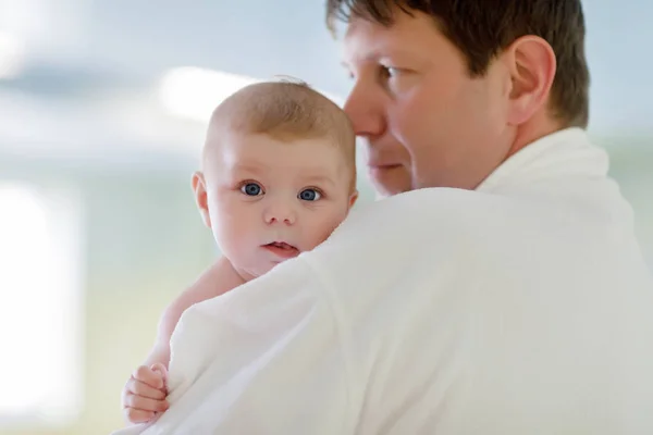 Young father and his little cute newborn baby daughter together in spa hotel. — Stock Photo, Image