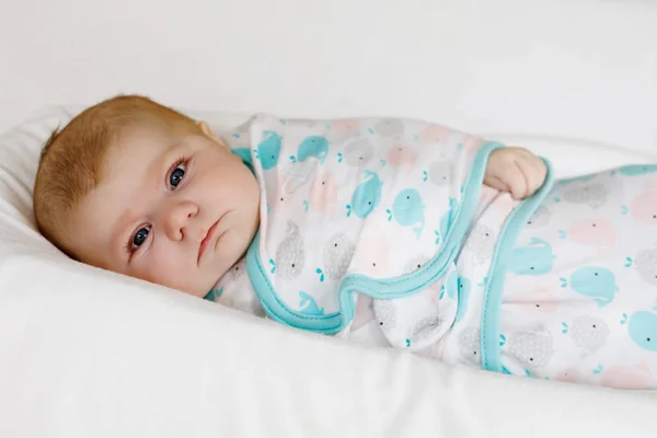 Cute little newborn baby girl wrapped in white blanket — Stock Photo, Image