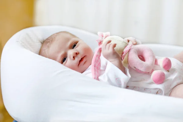 Cute baby girl playing with plush animal toy — Stock Photo, Image