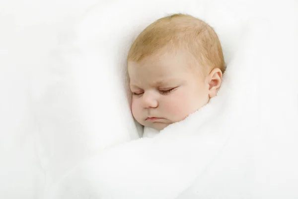 Мила маленька новонароджена дівчинка спить, загорнута в ковдру — стокове фото