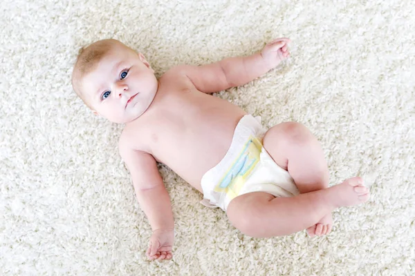 Newborn baby girl with diapers. Dry skin and nursery — Stock Photo, Image