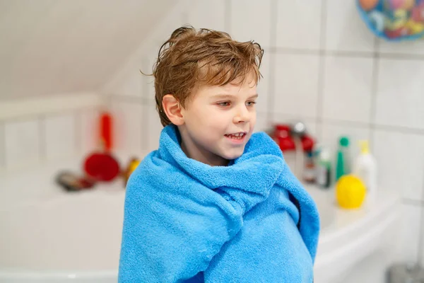 Niño feliz después de tomar un baño con toalla azul — Foto de Stock