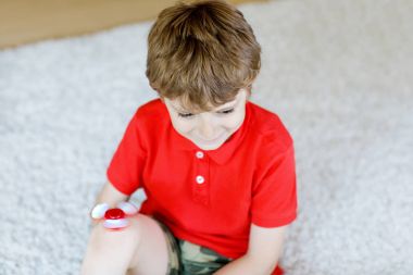 Tri kıpır el Spinner ile kapalı oynayan okul çocuk