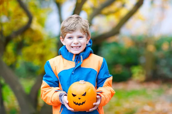 Happy cute little kid boy with halloween pumpkin lantern on autumn — Stock Photo, Image