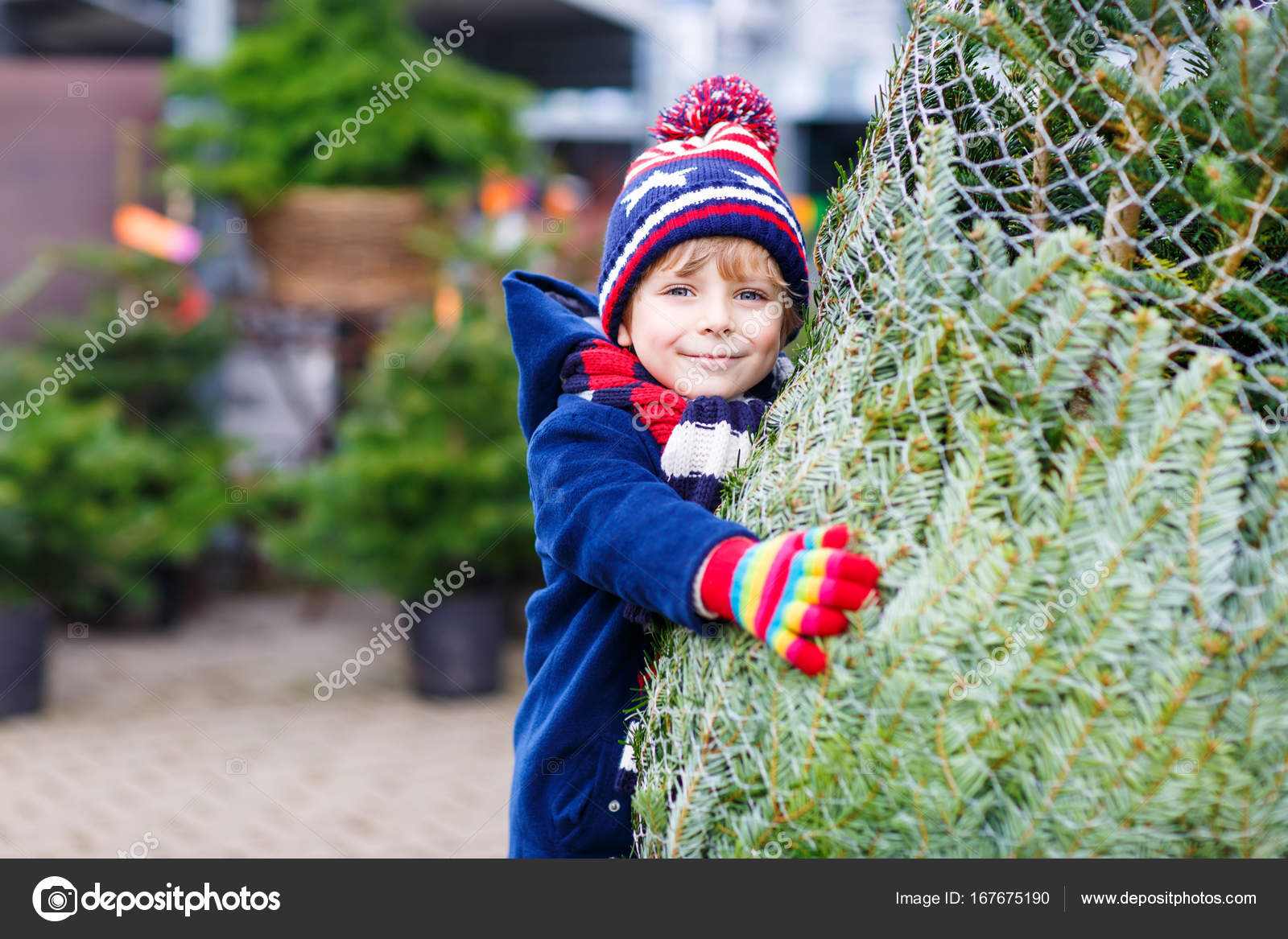 Niño pequeño en un sombrero con un hombre de nieve en el parque. — Foto