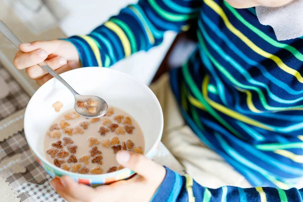 Fechar as mãos do garoto comendo cereais caseiros no café da manhã ou almoço — Fotografia de Stock