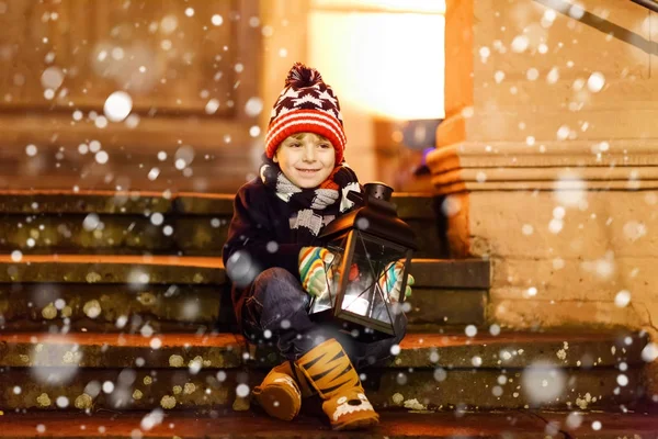 Kilisenin yanındaki merdivenlerde feneri olan sevimli bir çocuk..