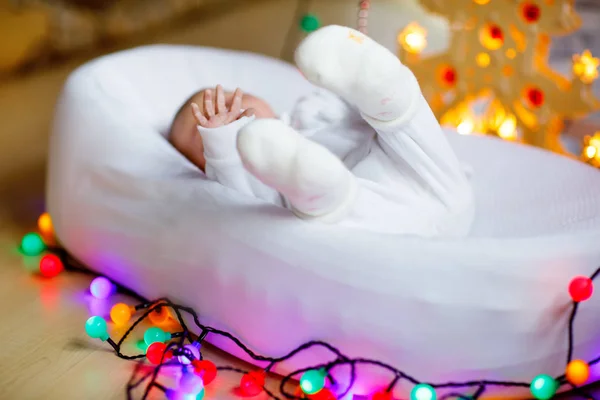 Een week oud pasgeboren babymeisje slaapt in de buurt van de kerstboom — Stockfoto