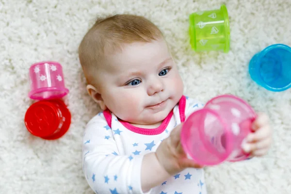 Cute adorable newborn baby playing with colorful educational rattle toy — Stock Photo, Image