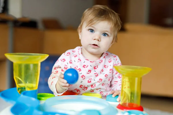 Adorable cute beautiful little baby girl playing with educational toys at home or nursery. — Stock Photo, Image