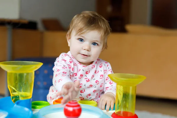 Adorable cute beautiful little baby girl playing with educational toys at home or nursery. — Stock Photo, Image