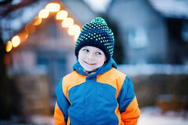 Menino feliz se divertindo com neve no inverno — Fotografia de Stock