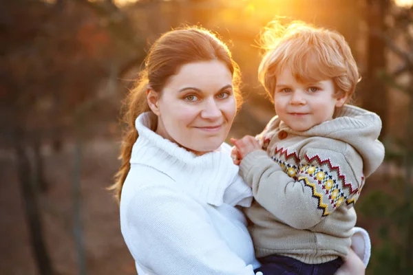 Mor och liten son i park eller skog, utomhus. — Stockfoto