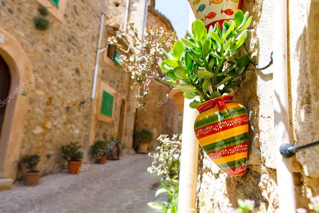 Beautiful street in Valldemossa with traditional flower decoration, famous old mediterranean village of Majorca. Balearic island Mallorca, Spain