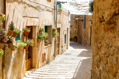 Beautiful street in Valldemossa with traditional flower decoration, famous old mediterranean village of Majorca. Balearic island Mallorca, Spain clipart
