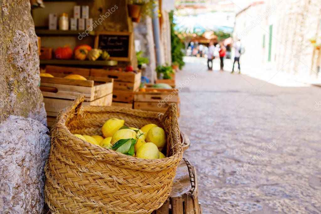 Fresh ripe lemons on a market in old village. Italy