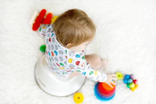 Closeup of cute little 12 months old toddler baby girl child sitting on potty. — Stock Photo, Image