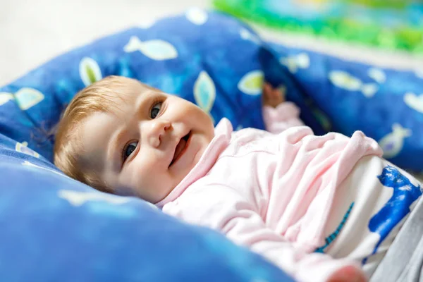 Baby Girl Wrapped Up In Newborn Blanket, New Born Kid Bundled Hat, One  Month On Carpet Stock Photo, Picture and Royalty Free Image. Image 44399180.