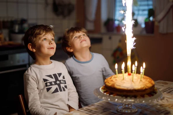 Two beautiful kids, little preschool boys celebrating birthday and blowing candles — Stock Photo, Image