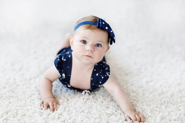 Roztomilý rozkošný holčička v modré šaty a čelenka. — Stock fotografie