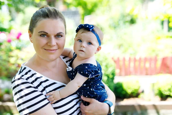 Cute little baby girl with mother on summer day in garden — Stock Photo, Image