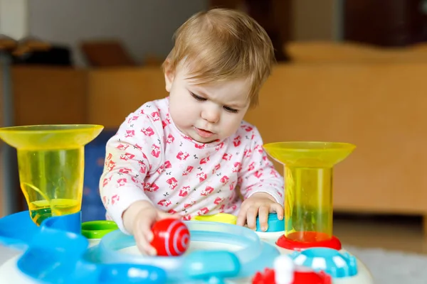 Adorable cute beautiful little baby girl playing with educational toys at home or nursery. — Stock Photo, Image