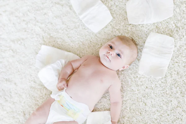 Newborn baby girl with diapers. Dry skin and nursery — Stock Photo, Image