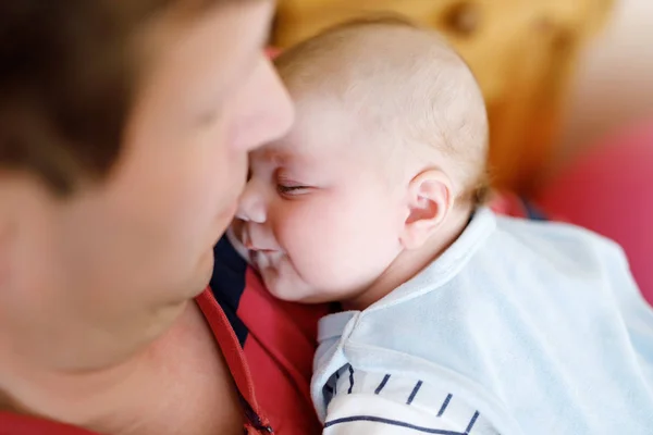 Happy proud young father holding little sleeping baby daughter, family portrait together. — Stock Photo, Image