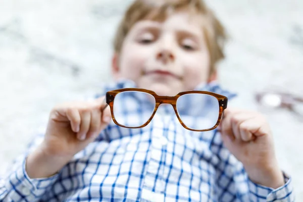 Close-up portrait of little blond kid boy with brown eyeglasses — Stock Photo, Image