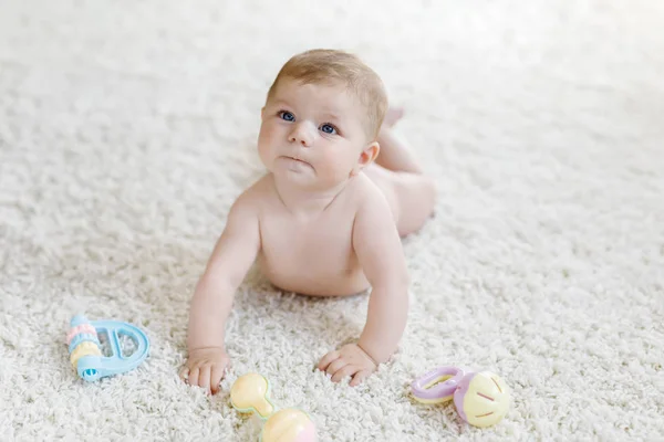 Cute baby girl playing with colorful pastel vintage rattle toy — Stock Photo, Image