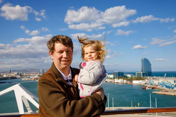 Happy cute little toddler girl on arms of dad on cruise ship. Adorable baby child and father, middle-aged man making family vacations cruising through Europe and Mediterranean Sea — Stock Photo, Image