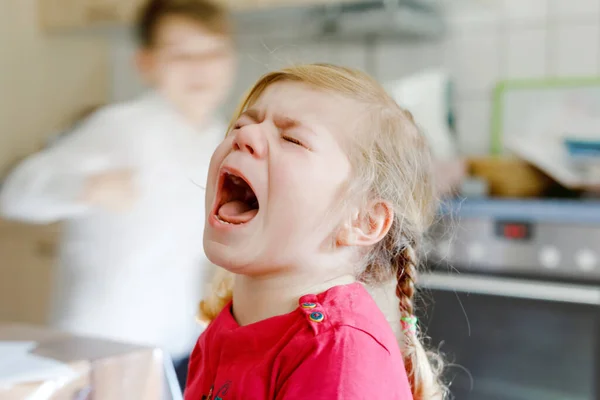 Aranyos feldúlt, boldogtalan kislány sír. Dühös, érzelmes gyerek kiabál. A könnyes gyerek portréja. — Stock Fotó
