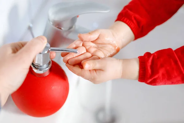 Closeup of little toddler girl washing hands with soap and water in bathroom. Close up child learning cleaning body parts. Hygiene routine action during viral desease. kid at home or nursery. — Stock Photo, Image