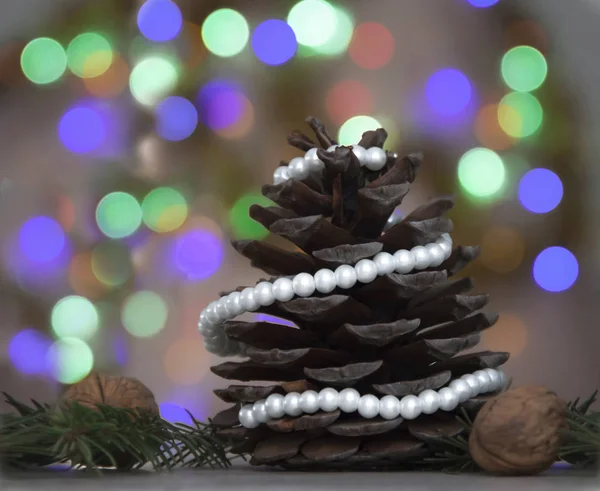 Large pine cone decorated with white beads — Stock Photo, Image