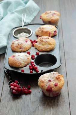 Kırmızı kuş üzümü ile kekler ile pudra şekeri serpilir. 