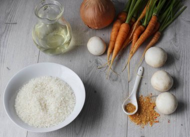 Malzemeler: pirinç, mantar, havuç ve soğan gri arka plan üzerinde. Kopya alanı